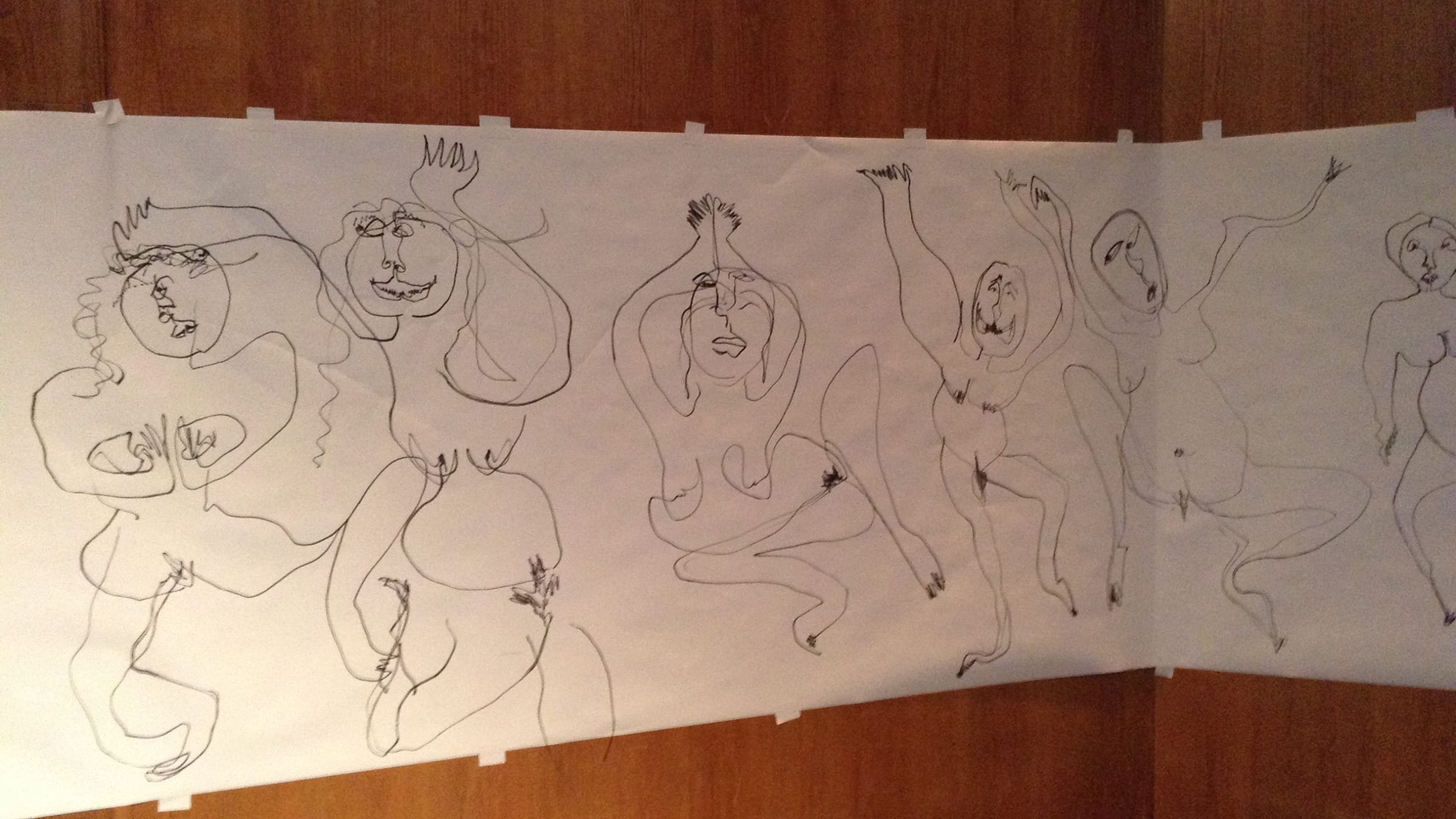 A large paper mural is taped to a wooden surface, featuring abstract line drawings of six nude women in dynamic poses, emphasising movement and expression.