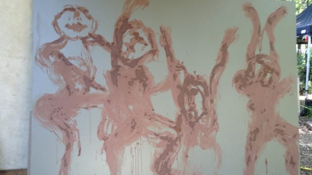 Four abstract figures with raised arms, painted in a warm brown hue, express joy and movement against a light white background.