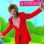 A poster of a vibrant scene featuring a musician in a bright red suit holding a guitar and a child with dark curly hair, set against a colourful, animated illustration of nature.