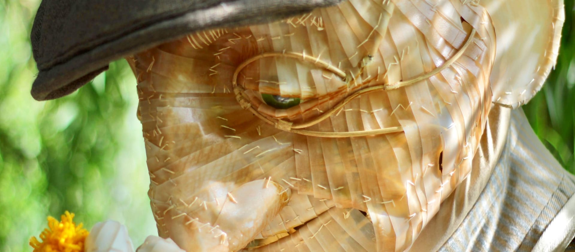 close up of a puppet head with a flat cap on holding a dandelion Walk of the Dandelion | Luke Brown