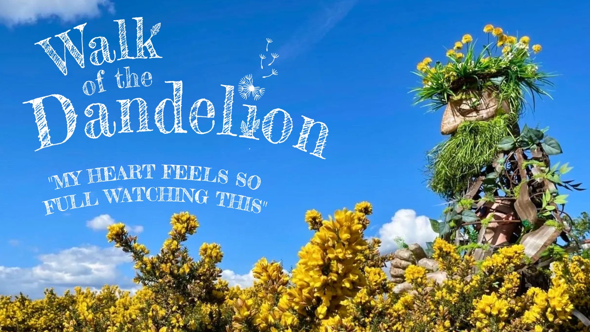 large wooden puppet with green foliage for hair and beard against yellow and green bushes and blue sky with low white clouds, writing says 'Walk of the Dandelion' and shows an audience quote which says 'my hear feels so full watching this' Walk of the Dandelion | Luke Brown © Tom Byrne