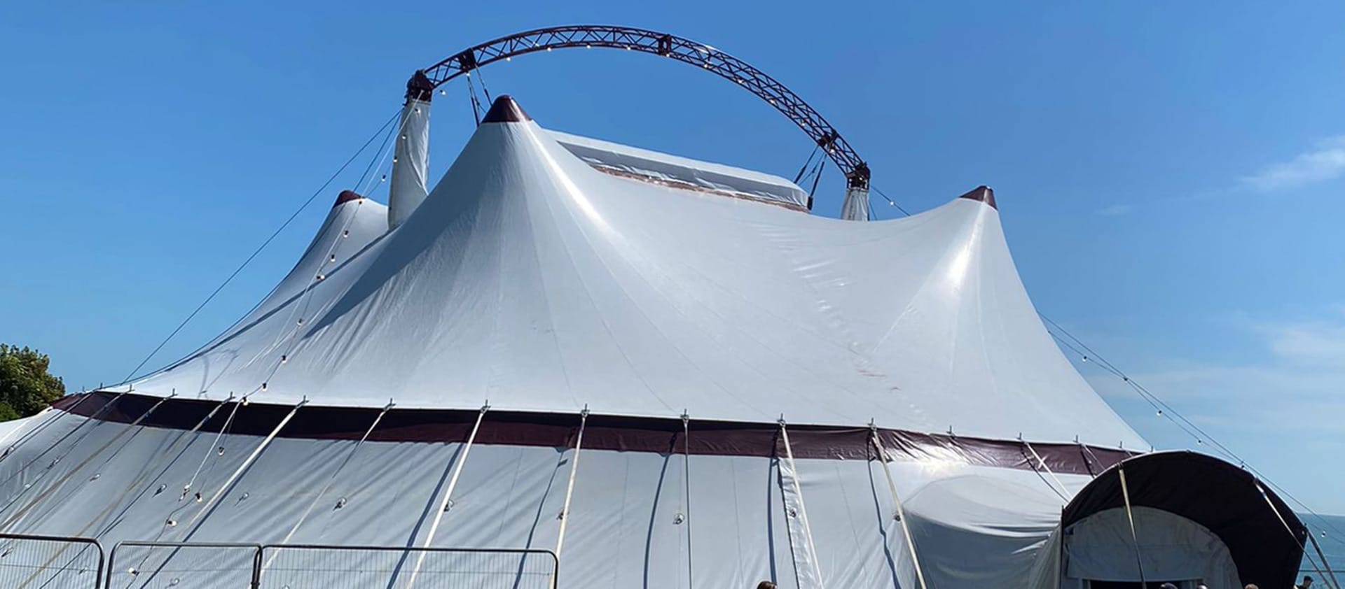 a white 'big top' tent against a blue sky and seascape Artist Inspiration Trip | Ventnor 2024 Artist Breakfast Ventnor Fringe